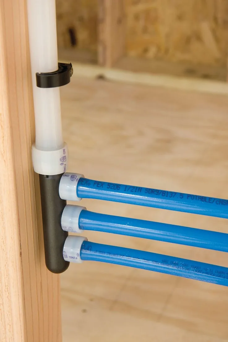Blue PEX lines leaving a manifold fastened to a wall stud – Main Water Shutoff Valve Replacement for Laguna Hills, CA homes